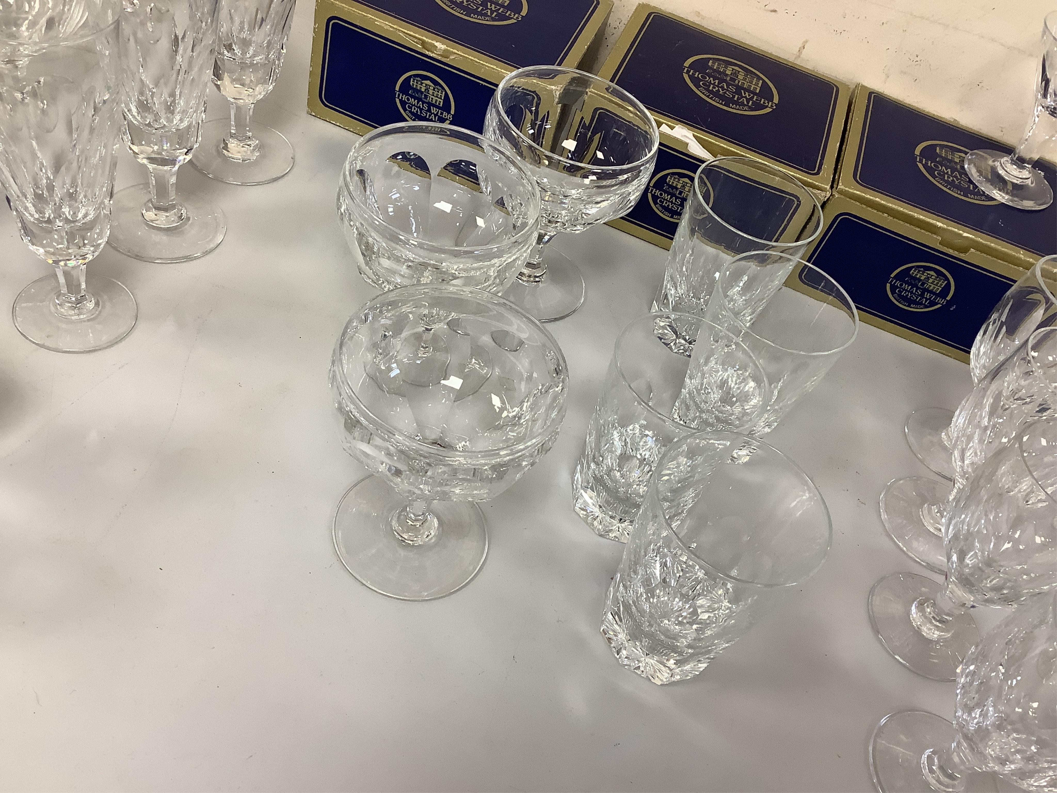 A suite of Thomas Webb Crystal wine glasses, Royal Yacht pattern, including two decanters, eight goblets, white wines and clarets, sixty-four pieces. Condition - mostly good